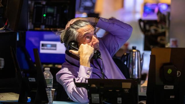 A rise in real bond yields is potentially bad news for growth assets such as shares and commodities. Above, a trader works on the floor of the New York Stock Exchange. Picture: Bloomberg