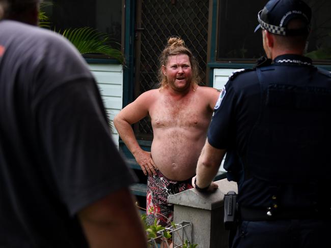 Police and SES advise a resident to evacuate a low lying area of Ayr ahead for the storm’s arrival. Picture: Dan Peled/AAP