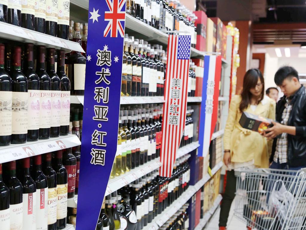 Chinese customers shop for wine imported from Australia, the United States or France at a supermarket in Xuchang city in 2013.