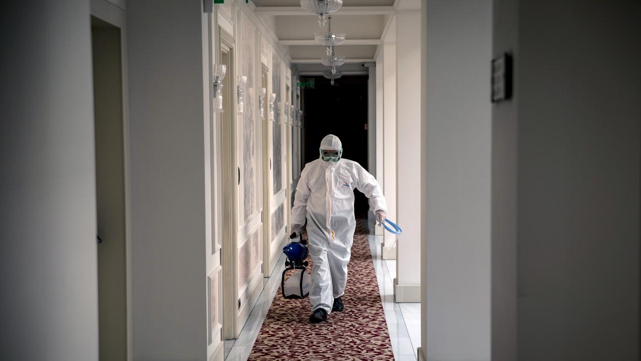 A hotel employee carrying a disinfecting spray is seen in a hallway of Istanbul's historic Pera Palace Hotel on July 04, 2020 in Istanbul, Turkey. Picture: Chris McGrath/Getty Images