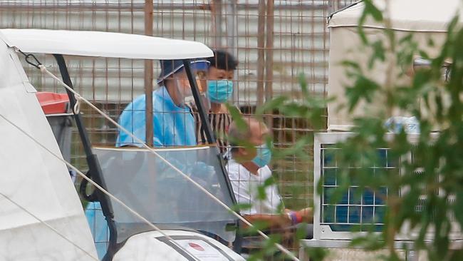 A man is evacuated from the Howard Springs quarantine facility on February 21 after testing positive to coronavirus. Picture GLENN CAMPBELL