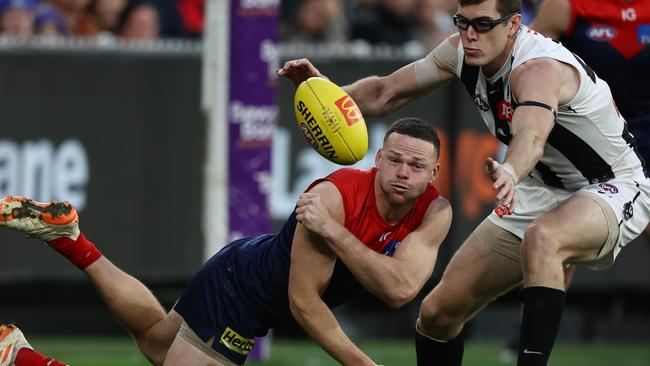 MELBOURNE - June 12: AFL. Steven May of the Demons clears by hand in front of Mason Cox of the Magpies during the round 13 AFL match between Melbourne and Collingwood at the MCG on June 12, 2023, in Melbourne, Australia. Photo by Michael Klein.