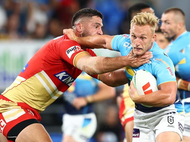 GOLD COAST, AUSTRALIA - MARCH 30: Tanah Boyd of the Titans is tackled by Jesse Bromwich of the Dolphins during the round four NRL match between Gold Coast Titans and Dolphins at Cbus Super Stadium, on March 30, 2024, in Gold Coast, Australia. (Photo by Chris Hyde/Getty Images)