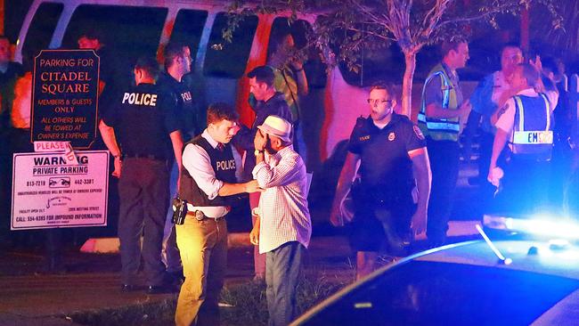 Police talk to a man outside the Emanuel AME Church. Picture: Wade Spees/The Post And Courier via AP