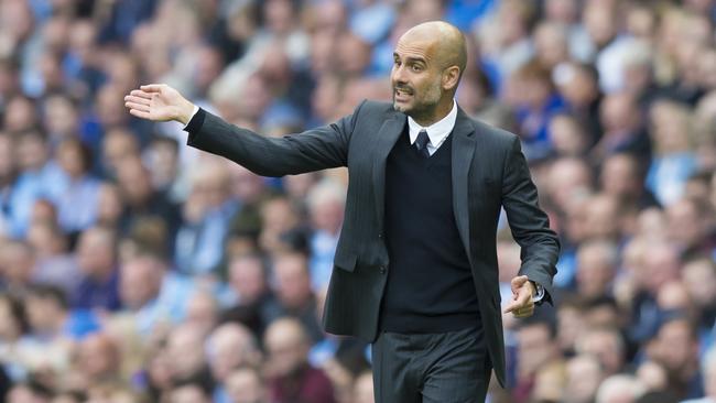 Manchester City's new manager Pep Guardiola issues instructions.