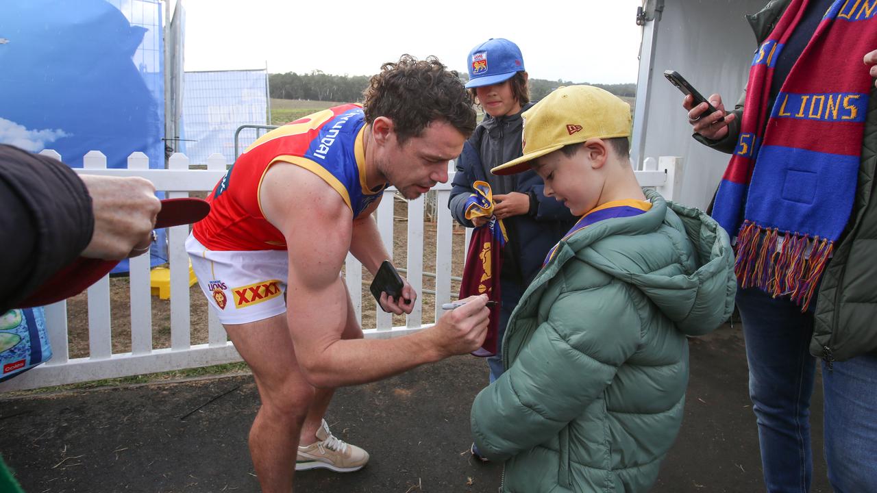 Brisbane Lions Brownlow medalist Lachie Neale signs autographs for Tom Harper of Albert Park, Victoria, at Mount Barker Oval during the AFL Gather Round. Picture: Brett Hartwig