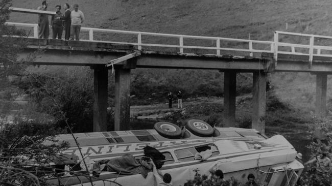 Passengers climbing out of a bus after it ran off a bridge.