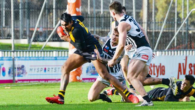 Glenelg’s Timmy Sumner evades his Port Adelaide opponents at Glenelg Oval. Picture: AAP/Brenton Edwards