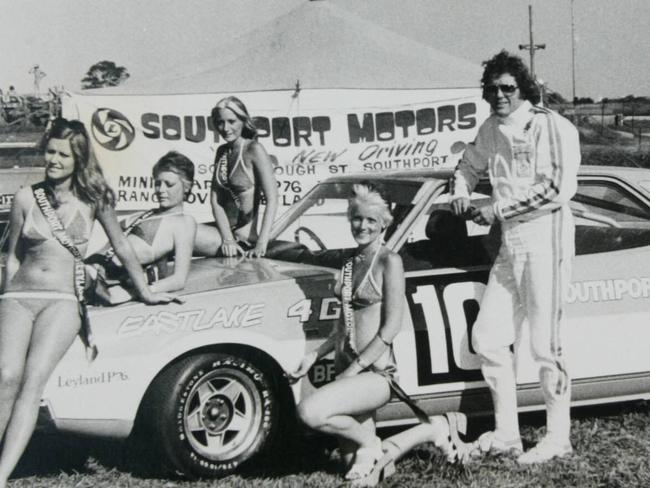 1970s copy photo of TV personality Darrell Eastlake with his Leyland P76 car, which he races, and bikini-clad admirers (location not known).