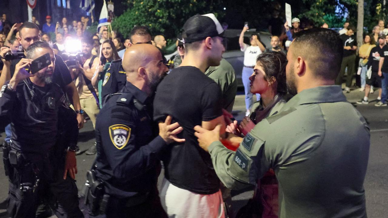 Members of Israel's security forces detain a man during a protest in Tel Aviv by relatives and supporters of hostages. Picture: AFP