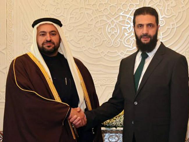 This handout picture released by the official Syrian Arab News Agency (SANA) shows Qatar's Minister of State Mohammed bin Abdulaziz al-Khulaifi (L) being received by Hayat Tahrir al-Sham (HTS) leader Ahmed al-Sharaa (also known as Abu Mohammad al-Jolani) in Damascus on December 23, 2024. (Photo by SANA / AFP) / == RESTRICTED TO EDITORIAL USE - MANDATORY CREDIT "AFP PHOTO / HO / SANA" - NO MARKETING NO ADVERTISING CAMPAIGNS - DISTRIBUTED AS A SERVICE TO CLIENTS ==