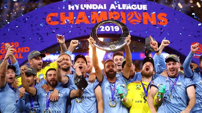 Sydney FC captain Alex Brosque lifts the A-League trophy after his team beat Perth Glory in a penalty shootout at Optus Stadium. Picture: Getty Images