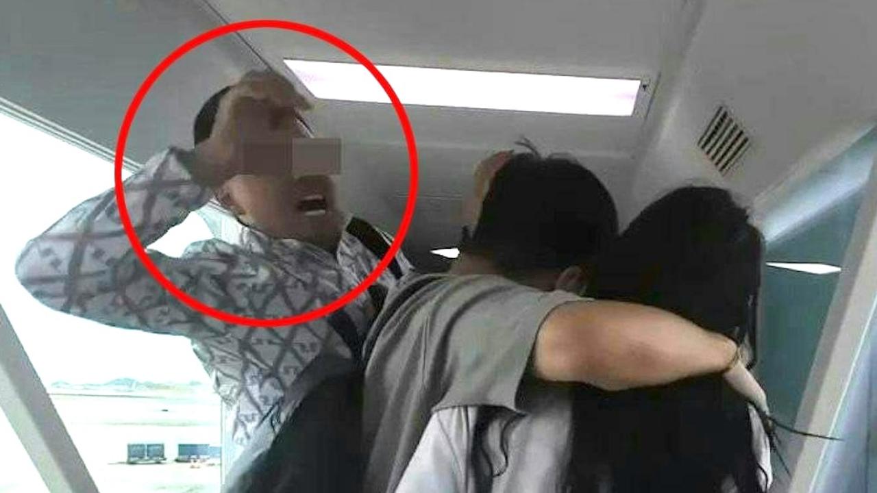 A passenger attacking a couple who engaged in an argument with a flight attendant while exiting a flight.