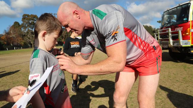 Barry Hall signs an autograph for a young fan. Picture: Alex Coppel