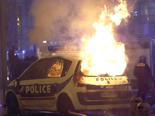 A police car burns after clashes between police and protesters, in Marseille, southern France, Saturday, Dec. 1, 2018, demonstrating against what they claim were dilapidated residential buildings that collapsed Monday Nov. 5, killing eight people.  French authorities on Saturday deployed some thousands of police on Paris' Champs-Elysees avenue to try to contain protests by people angry over rising taxes and President Emmanuel Macron's government. (AP Photo/Claude Paris)