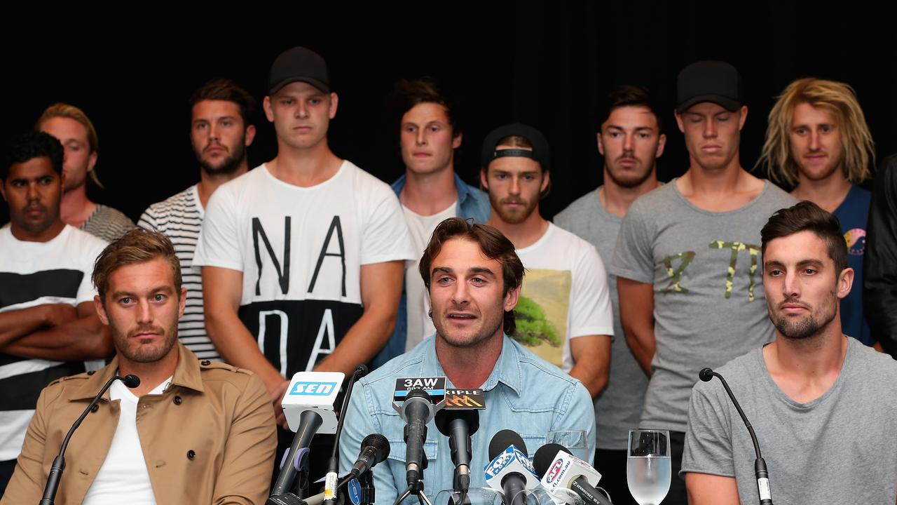 Jobe Watson, flanked by his teammates, talks to the media after the AFL anti-doping tribunal announced that 34 past and present Essendon players had been found not guilty of taking a banned substance. The players would ultimately be banned. Picture: Getty Images