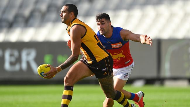 Marcus Adams (right) attempt to tackle Hawthorn’s Shaun Burgoyne in the Lions’ round one match at the MCG. Photo: Quinn Rooney/Getty Images