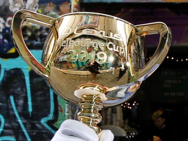 WARNING! HOLD FOR HERALD SUN.  Melbourne Cup trophy travels around Melbourne to by held by everyday people. The cups has been traveling for several months around the globe and Australia meeting famous and not so famous. Now it's back home in Melbourne. Cafe barista Sarah Bott excitedly holds the Melbourne Cup in Hosier Lane.    Picture: David Caird