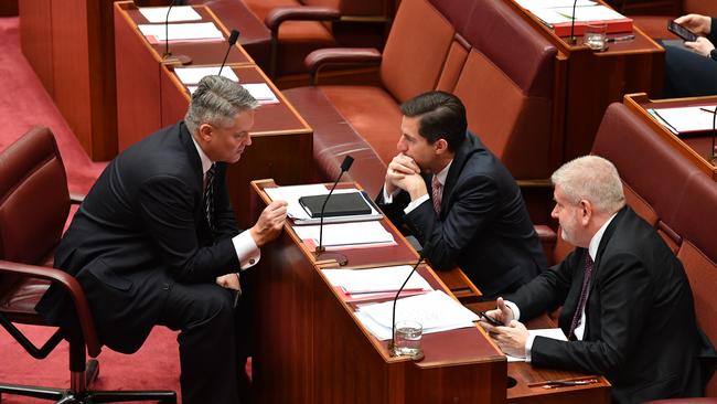 Minister for Finance Mathias Cormann, Minister for Trade Simon Birmingham and Minister for Communications Mitch Fifield during scenes of confusion over the "OK To Be White" motion this week. Picture: AAP Image/Mick Tsikas