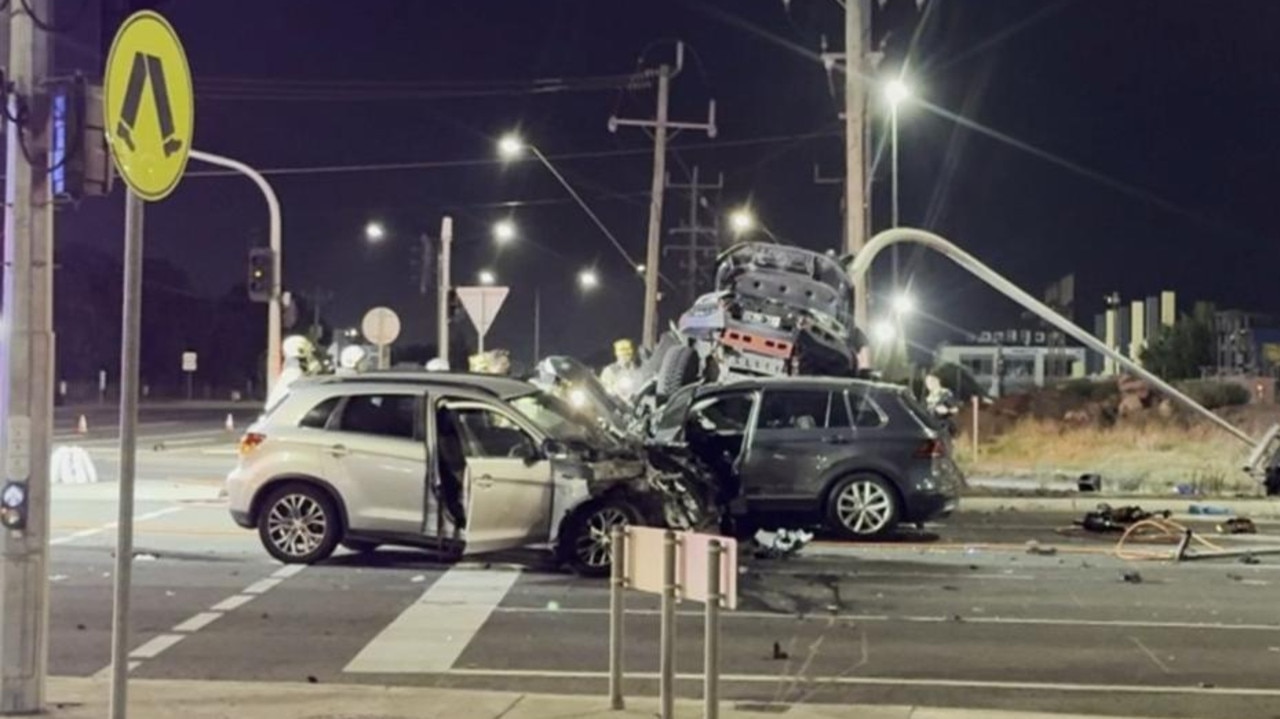 Police say the black Ford Ranger collided with the silver Mitsubishi, then hit a traffic light pole and a silver Volkswagen. Picture: 7News