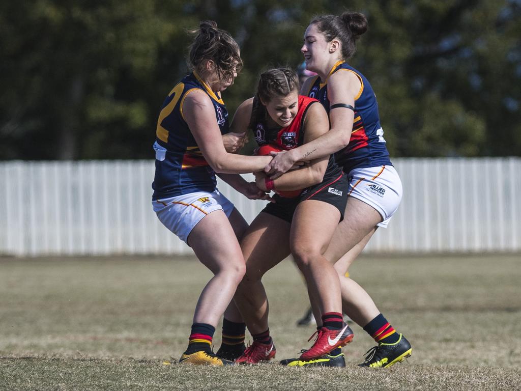 Georgia Fregonese of South Toowoomba is held by Nicole Mairs (left) and Kendyl Scott of University in AFL Darling Downs senior women's round 9 at Heritage Oval, Saturday, June 19, 2021. Picture: Kevin Farmer