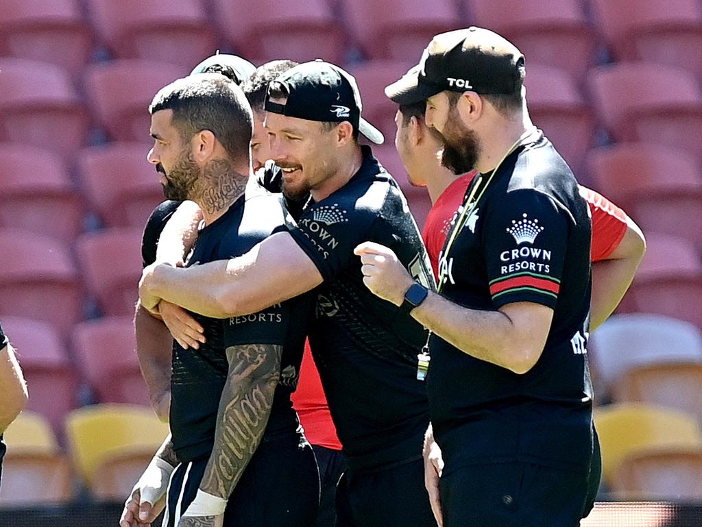 Damien Cook embraces Adam Reynolds during the South Sydney Rabbitohs captain’s run. Picture: Bradley Kanaris/Getty Images