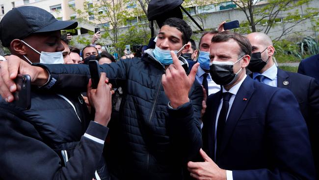 Emmanuel Macron poses for selfies in La Mosson neighbourhood during his visit to Montpellier, southern France, to discuss security and policing. Picture: AFP