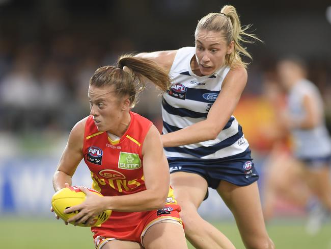 MACKAY, AUSTRALIA - MARCH 06: Jamie Stanton of the Suns handles the ball during the round five AFLW match between the Gold Coast Suns and the Geelong Cats ay Great Barrier Reef Arena on March 06, 2020 in Mackay, Australia. (Photo by Albert Perez/Getty Images)