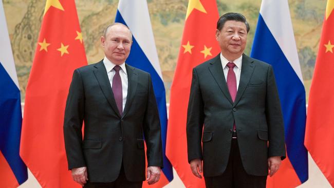 ‘Common views’: Xi Jinping rolls out the welcome mat for Vladimir Putin at Beijing’s Diaoyutai State Guesthouse late on Friday. Picture: Reuters