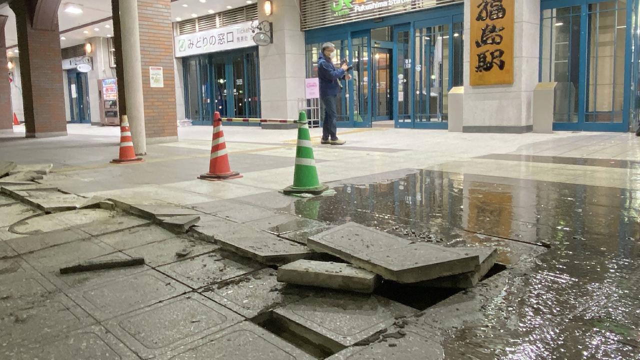 A picture shows damaged pavement blocks on the ground in front of JR Fukushima Station, which seem to have been cracked due to the impact of the earthquake. Picture: AFP