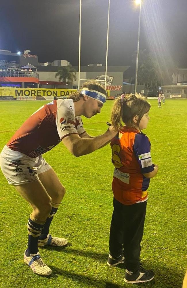 Liam Hampson signing a fans shirt after a rugby game with the Redcliffe Dolphins.