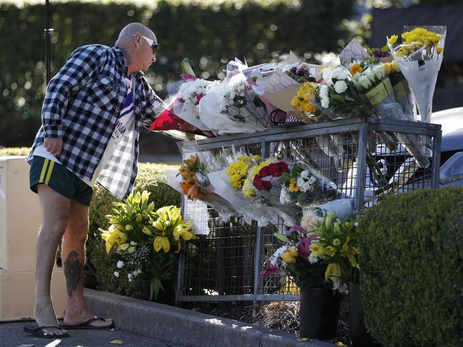 A man leaving flowers at Campbelltown McDonald’s on Saturday morning. Picture: Tim Hunter