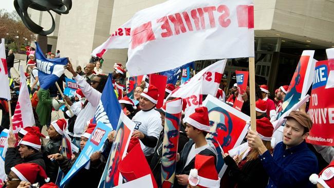 Workers and protesters in DC campaign for the minimum wage to be increased to $15 per hour. Picture: AFP. 