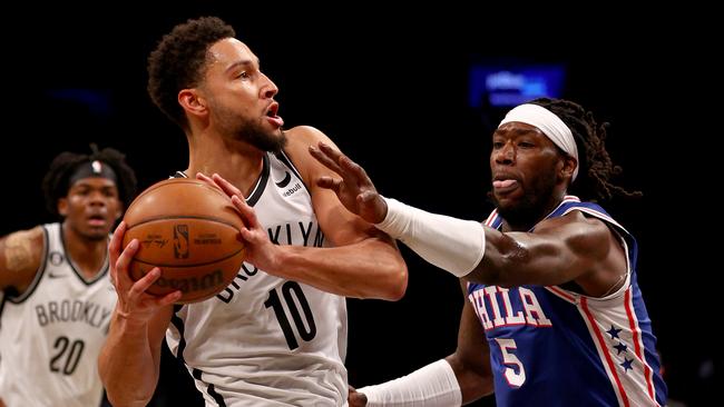 NEW YORK, NEW YORK - OCTOBER 03:  Ben Simmons #10 of the Brooklyn Nets tries to keep the ball from Montrezl Harrell #5 of the Philadelphia 76ers in the first half during a preseason game at Barclays Center on October 03, 2022 in the Brooklyn borough of New York City. NOTE TO USER: User expressly acknowledges and agrees that, by downloading and or using this photograph, User is consenting to the terms and conditions of the Getty Images License Agreement. (Photo by Elsa/Getty Images)