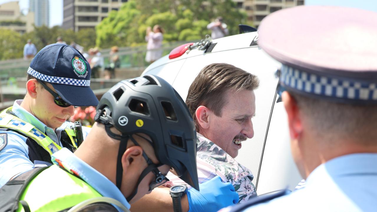 He was escorted away by police. Picture: NCA NewsWire / Nicholas Eagar