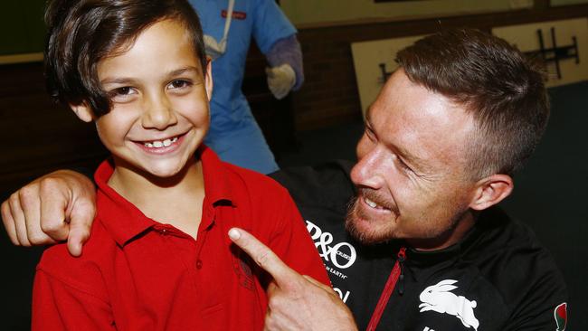 Darlington Public School student Kian Walhers, 8, shows off his smile to Rabbitohs player Damien Cook. Picture: John Appleyard