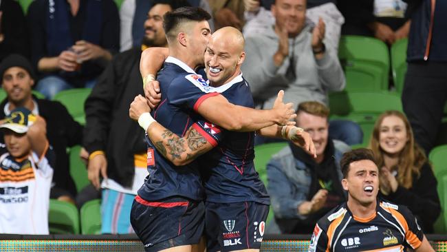 Rebels players Jack Maddocks (left) and Billy Meakes celebrate after Maddocks scored against the Brumbies on Friday night. Picture: AAP   