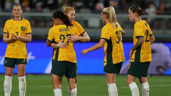 Matildas veteran Clare Polkinghorne is congratulated by teammates as she left the field in her final international.