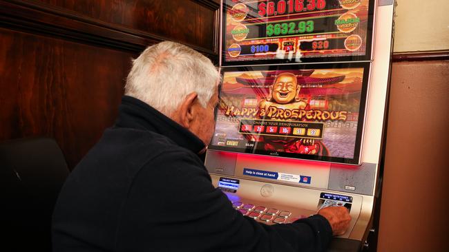 Stock image of man at pokie machine. Picture: NCA Newswire / Gaye Gerard