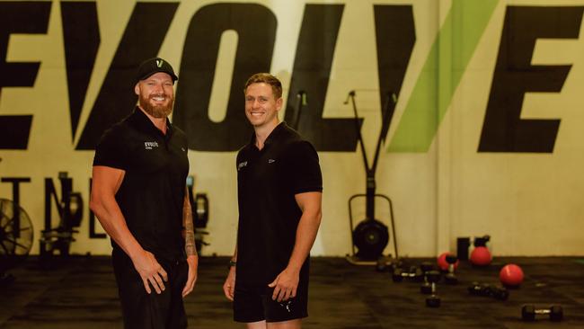 Evolve Fitness NT owner and personal trainer Matt Cowling, left, pictured in his gym with fellow personal trainer Jacob Phillips. Picture: Glenn Campbell