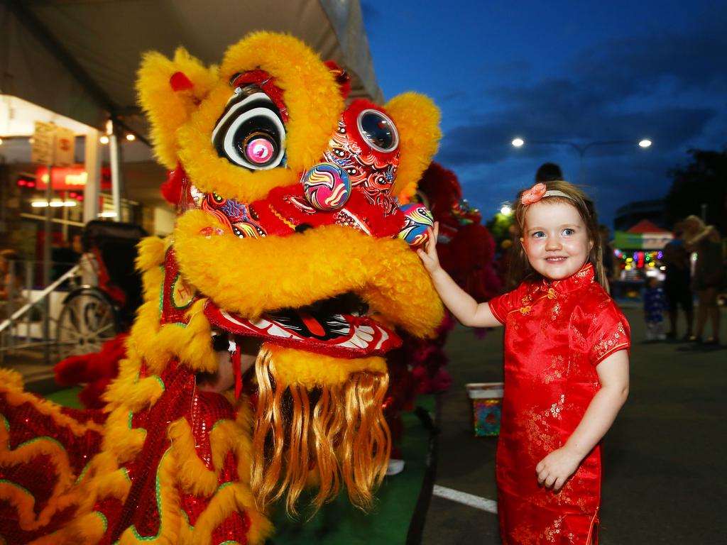 Freya Stark, 3, of Manoora, gets acquainted with a CADCAI lion at the Cairns and District Chinese Association Inc Chinese New Year street festival on Grafton Street. PICTURE: BRENDAN RADKE