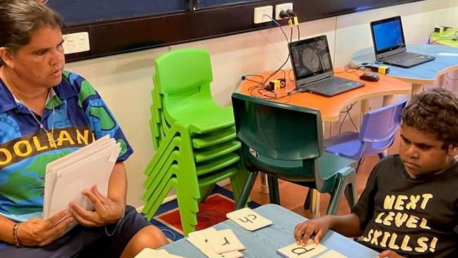 Kellyann Daly teaching student Edmund Brooks in the classroom at Woolianna School in Daly River. Picture: Supplied