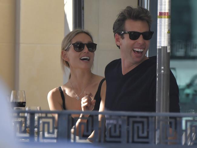 Hackett laughs with his mystery blonde at the Versace restaurant on the Gold Coast.