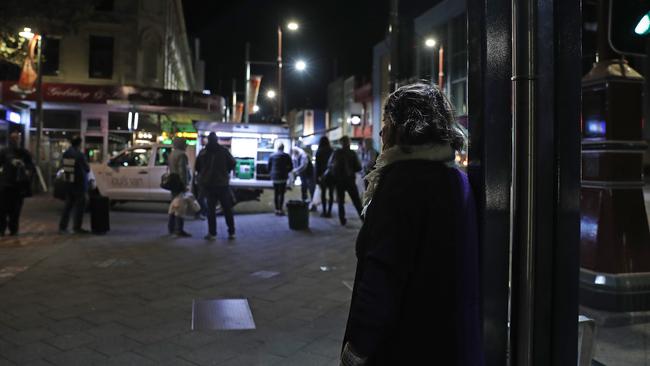 Homeless people line up for food from Loui’s Van in Elizabeth Street mall. Picture: LUKE BOWDEN