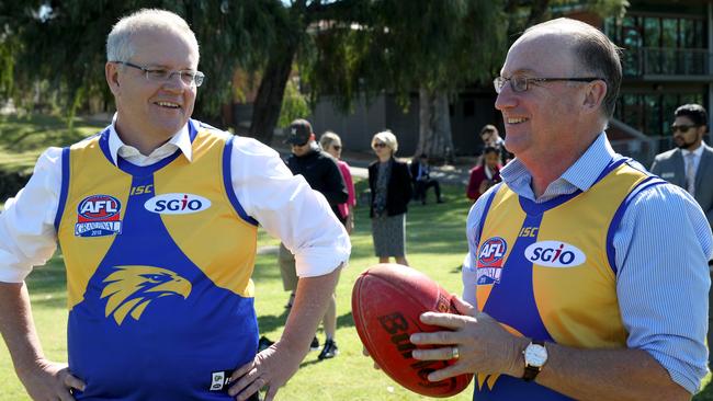 Scott Morrison, left, and MP Steve Irons wearing West Coast Eagles AFL jumpers in Perth on Tuesday. Picture: AAP