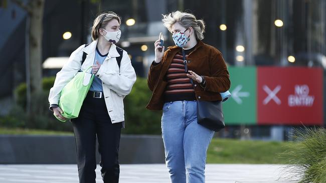 People are seen wearing masks in Melbourne. Picture: Daniel Pockett