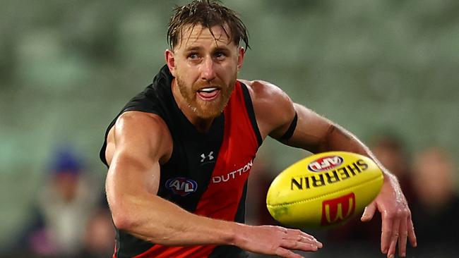 MELBOURNE, AUSTRALIA - JUNE 29: Dyson Heppell of the Bombers kicks during the round 16 AFL match between Geelong Cats and Essendon Bombers at Melbourne Cricket Ground on June 29, 2024 in Melbourne, Australia. (Photo by Graham Denholm/Getty Images)