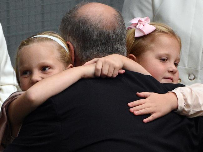 Well done dad... The Treasurer is hugged by daughters Lily (left) and Abbey (right) last night.