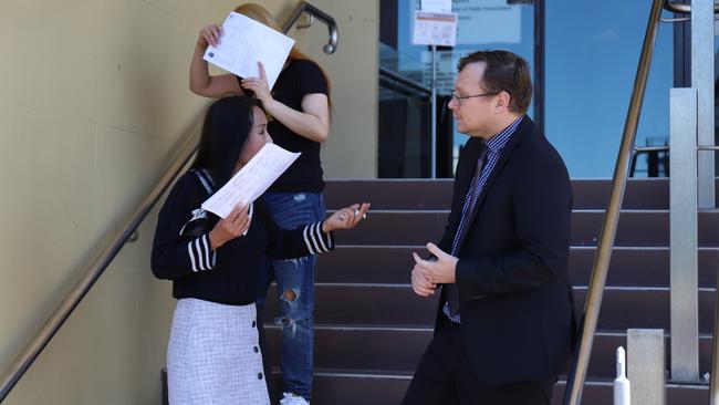 Ling Yao (top) and Pu Liu faced Mackay Magistrates Court where they were both sentenced for knowingly participating in the provision of prostitution and possessing tainted property. Liu speaks with her solicitor outside the courthouse.