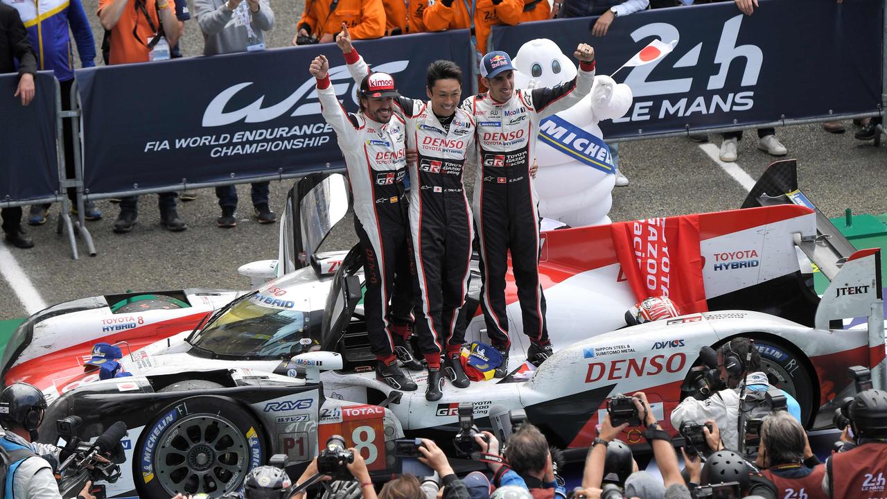 Fernando Alonso, Japan's Kazuki Nakajima and Switzerland's Sebastien Buemi celebrate after winning Le Mans.